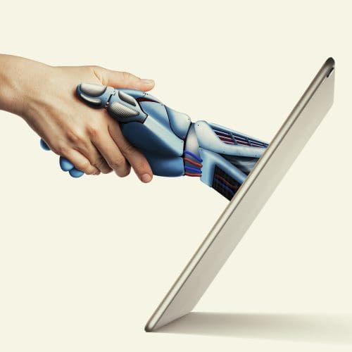 Robotic hand from an iPad screen shaking a human hand, symbolizing Conversational AI's role in modern marketing.